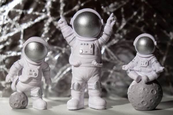 three figurines of space me showing fun and peacefulness